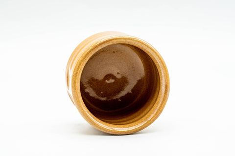 Angled view looking into the cup, showing the darker amber glaze pooled in the interior.
