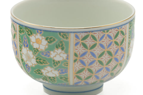 Closeup of the side of the yunomi detailing the green floral and blue geometric lattice pattern