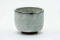 Side view of the milky white teacup.