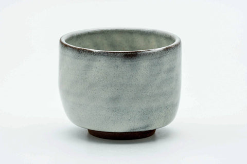 Side view of the milky white teacup.