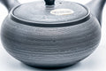 Rear view showing the side handle and dark textured clay