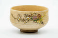 Kutani-yaki matcha chawan with a painted floral motif on a beige crazed glaze, three-quarter view