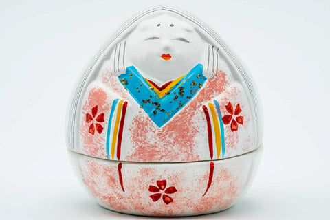 Front view of the closed kogo showing the painted woman in a pink kimono among cherry blossoms.