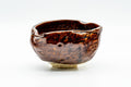 Front view of the katakuchi showing its wide mouth and pinched spout from another angle