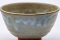 Front view of the chawan highlighting the mottled beige-and-grey glaze.