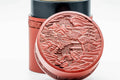 Close-up of the carved village landscape scene on the lid