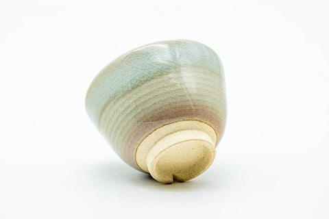 Teacup tilted to show the unglazed foot and base.