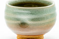 Close-up three-quarter view showing the glaze tones and thumb indentation.