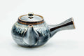 Side view of the drip-glazed kyusu with the handle to the right, lid on.
