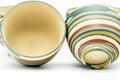 A nerikomi teacup tipped beside the set to show its interior and foot.