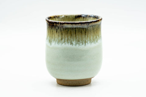 Front/side view showing the streaked drip glaze over the pale body.