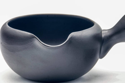 Close-up of the pouring spout and the blue-glazed interior rim.