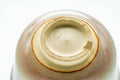 Underside of the cup showing the foot and an impressed maker's mark.