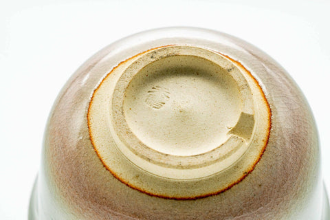 Underside of the cup showing the foot and an impressed maker's mark.