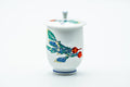 The covered yunomi with its knobbed lid in place, the turnip painting facing forward.