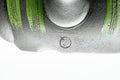 Top-down close-up of the lid knob and green stripes.