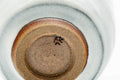 Underside of the teacup, showing the foot and a stamped maker's mark.