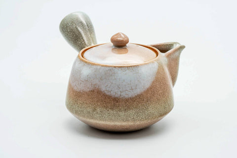 Beige-pink weathered Hagi-yaki kyusu, three-quarter view with the spout to the right and handle to the left