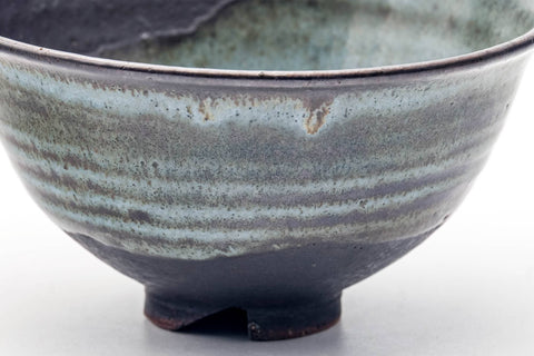 Close side view emphasising the horizontal banding and blue-green drip glaze.