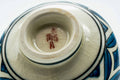 Underside of the teacup, showing the foot and a maker's mark.