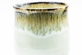 Close-up of the rim showing the brown hare's-fur glaze dripping over the white body.