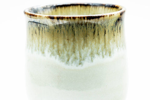 Close-up of the rim showing the brown hare's-fur glaze dripping over the white body.
