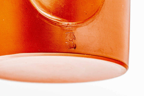 Closeup of the lower body and spout base of the smooth red shudei Tokoname dobin