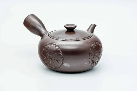 Purple-brown Banko-yaki kyusu, front view with the spout to the left and side handle to the right