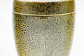 Close-up of the closed canister showing the gold-speckled texture.