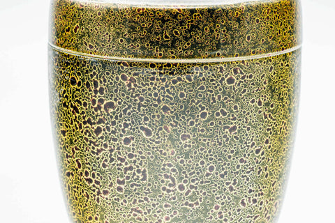 Close-up of the closed canister showing the gold-speckled texture.