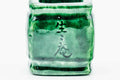 Closeup of one side of the futaoki showing an incised mark beneath the green glaze.