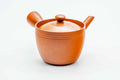 Front view of the red kyusu showing the spout, lid on.