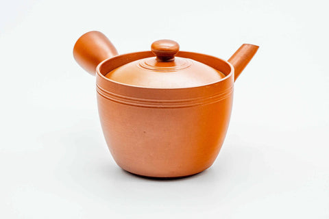 Front view of the red kyusu showing the spout, lid on.