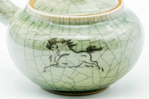 Closeup of the painted golden running-horse motif on the body of the Obori Soma kyusu