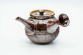Three-quarter view of the drip-glazed kyusu with the lid on.