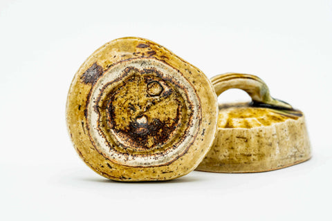 Three-quarter view of the open kogo showing the gilded floral decoration.