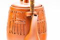 Close-up of the upper body, spout, and handle mounts, showing the engraved decoration.