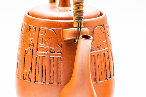 Close-up of the upper body, spout, and handle mounts, showing the engraved decoration.