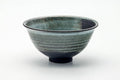 Front view of the chawan showing the streaked blue-green glaze and pale foot.