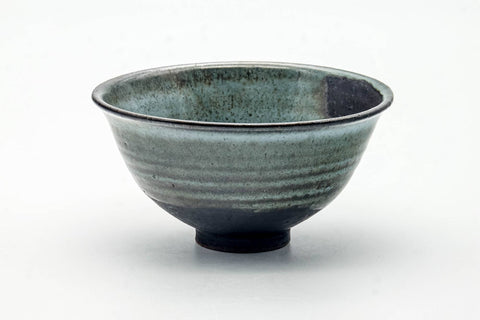 Front view of the chawan showing the streaked blue-green glaze and pale foot.