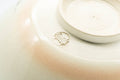 Japanese Matcha Bowl - Beige Gold Pond Leaves Kyo-yaki Summer Chawan - Juraku - 200ml - tilted view showing the foot and base mark