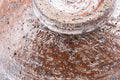 Close-up of the bowl's wall, showing the mottled, textured brown glaze.