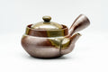 Front view of the teapot showing the domed lid knob and shimmering ash glaze.