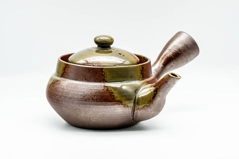 Front view of the teapot showing the domed lid knob and shimmering ash glaze.