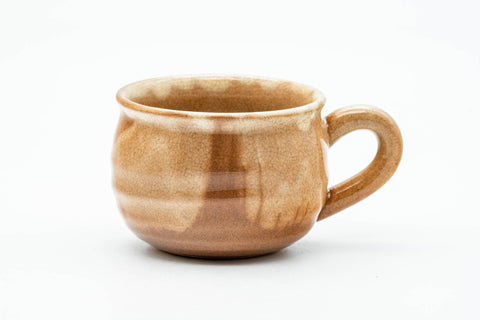 Handled teacup alone, front view, showing the C-shaped handle and ribbed body.