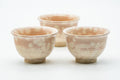 The three cups viewed from another angle, showing the soft pink spotting.