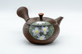 Textured brown Tokoname-yaki teapot by Kameoka Katsushi with a painted floral panel, three-quarter view, lid on and side handle to the right.