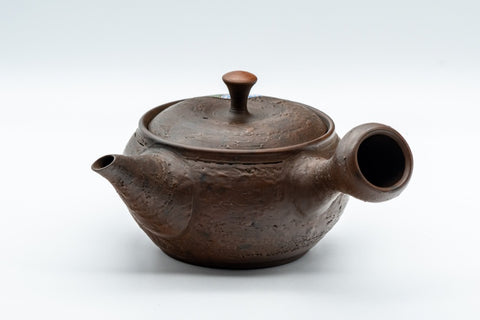 Side profile of the teapot with the spout to the left.