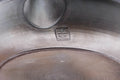 Mogake Seaweed Yōhen flat Tokoname teapot, underside view showing the foot and the maker's stamp - closeup