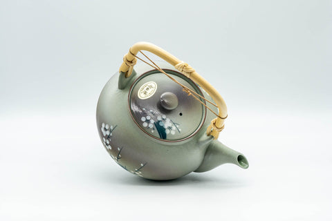 Japanese Tea Set - Green Arita-yaki Debeso Dobin Teapot with 2 Lidded Yunomi Teacups - angled view of the teapot showing the handle and plum blossom decoration